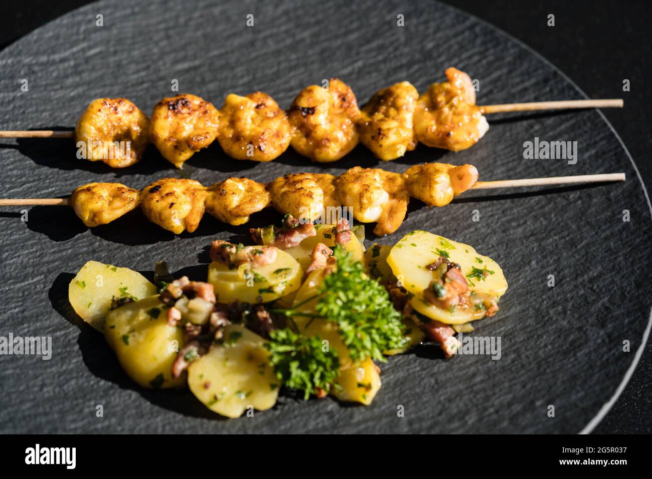 grilled White Tiger Prawns with Bacon Potato Salad Stock Photo