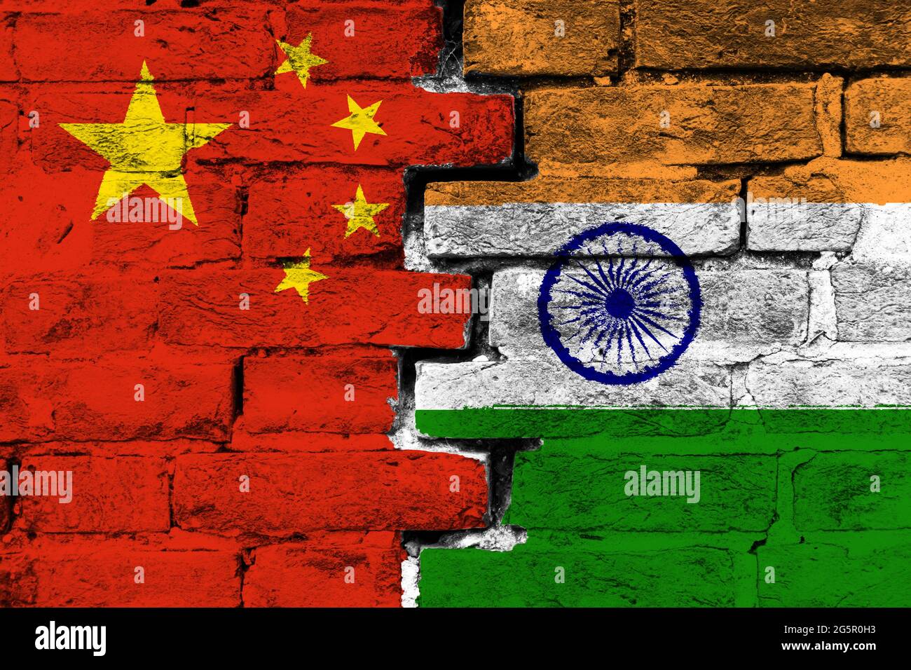 Concept of the relationship between China and India with two painted flags on a damaged brick wall Stock Photo
