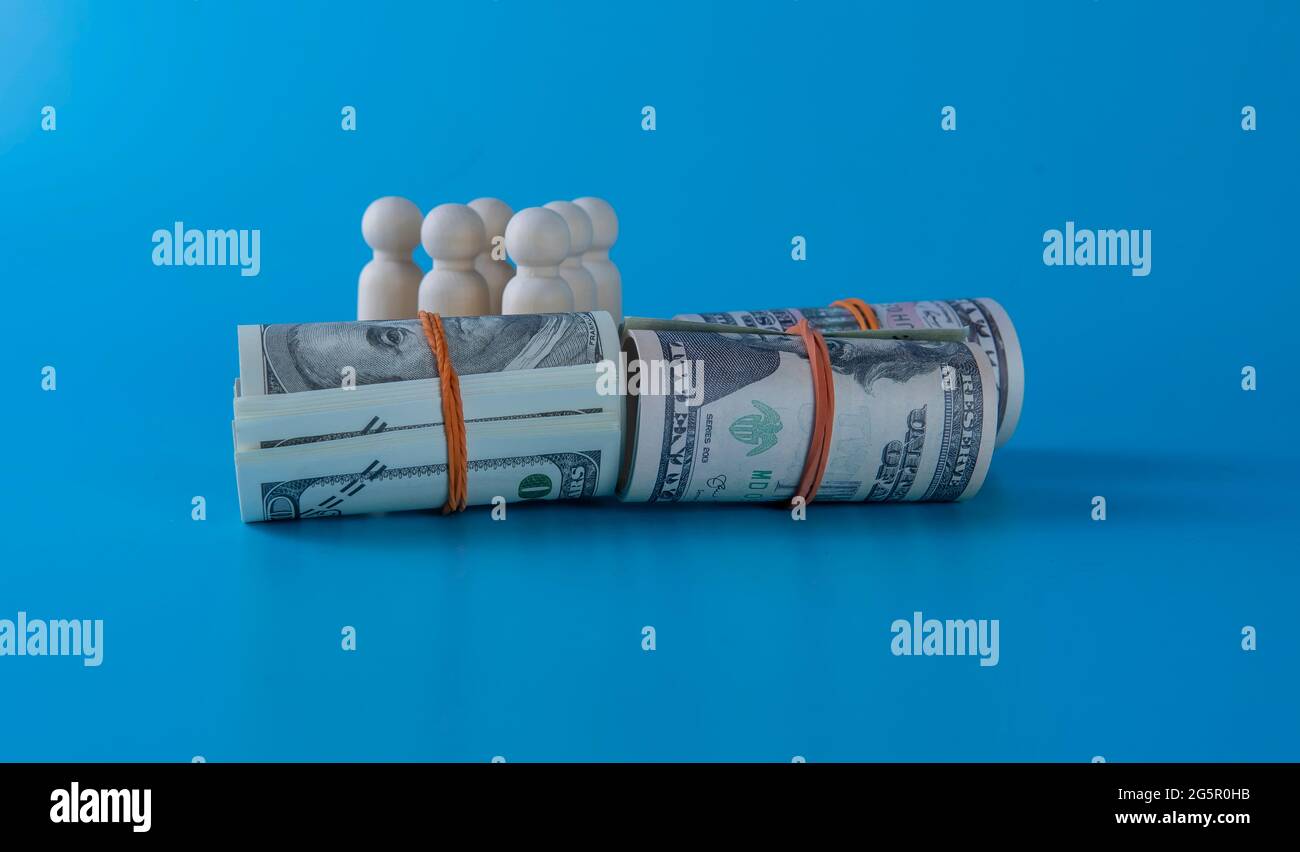 Wooden figures of people standing on money saving for concept investment mutual fund finance and pension retirement.Financial growth concept Stock Photo