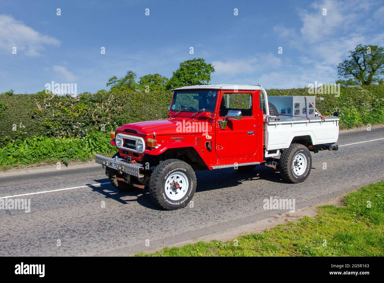 1977 70s red custom Toyota Land Cruiser 2360cc diesel truck en-route to Capesthorne Hall classic May car show, Cheshire, UK Stock Photo