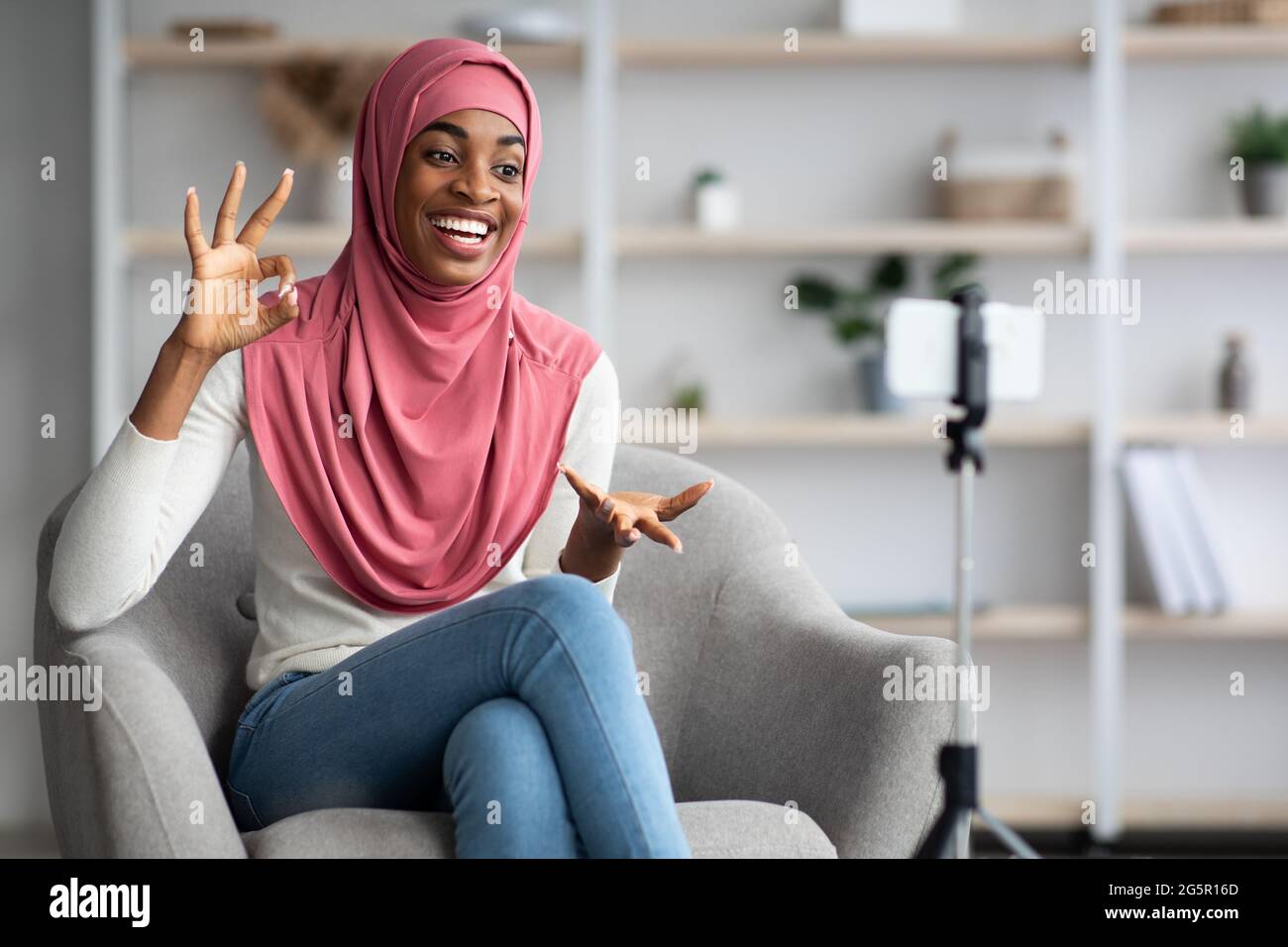 Black Islamic Lady In Hijab Using Smartphone For Recording Video At ...