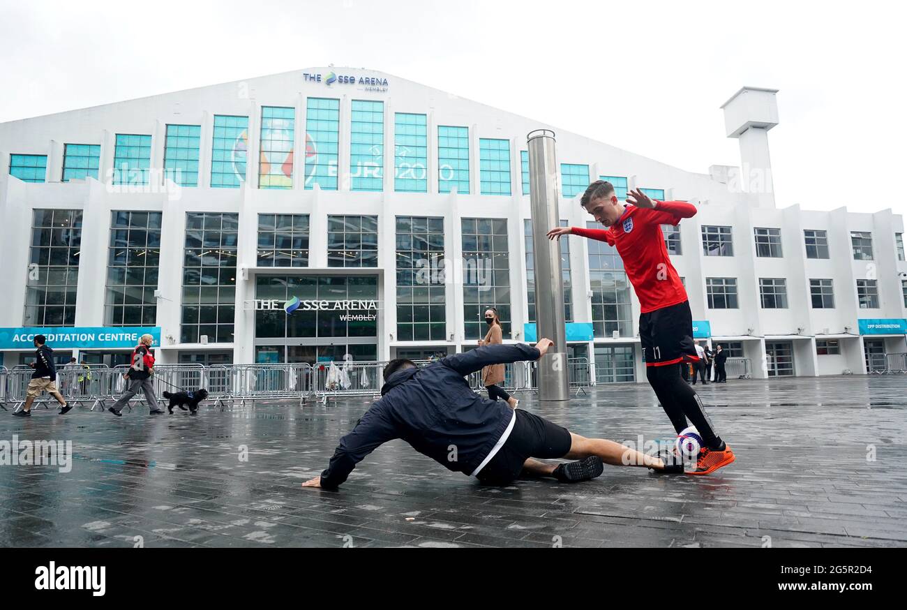 England fans play football outside Wembley Arena ahead of the UEFA Euro 2020 round of 16 match between England and Germany at Wembley Stadium. Picture date: Tuesday June 29, 2021. Stock Photo