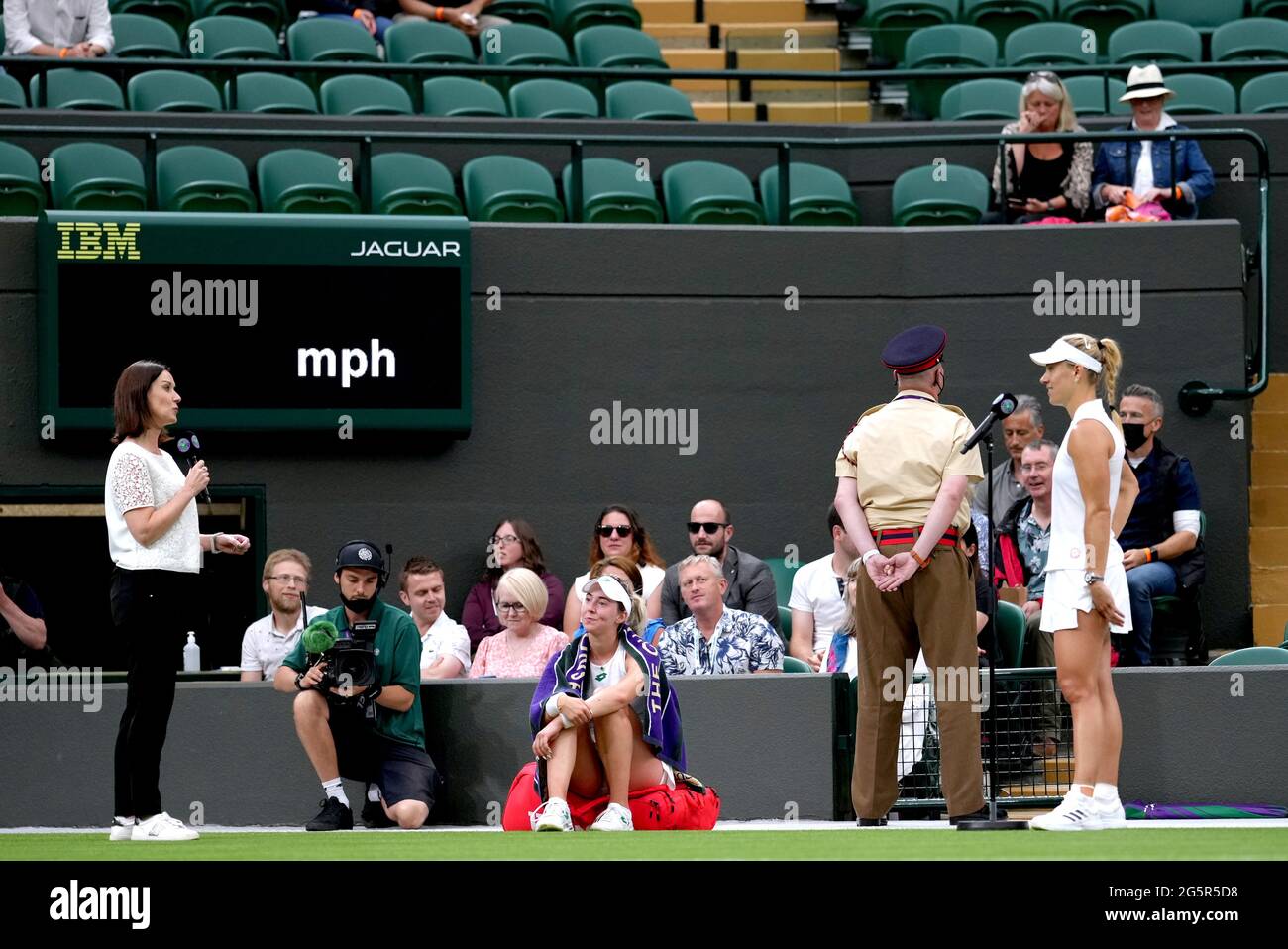 Angelique Kerber (right) is interviewed by Lee McKenzie after winning her first round ladies' singles match against Nina Stojanovic (centre) on court one on day two of Wimbledon at The All England Lawn Tennis and Croquet Club, Wimbledon. Picture date: Tuesday June 29, 2021. Stock Photo