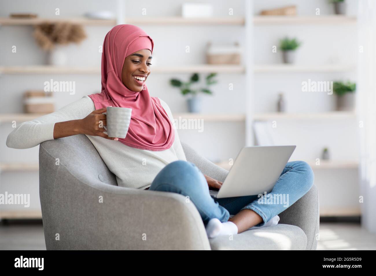 Black Woman In Hijab Resting With Laptop And Coffee At Home Stock Photo ...