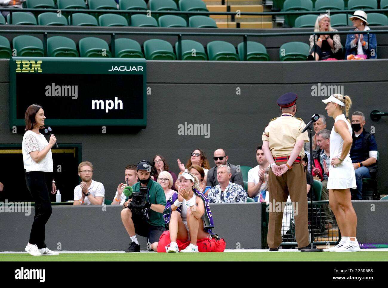 Angelique Kerber (right) is interviewed by Lee McKenzie after winning her first round ladies' singles match against Nina Stojanovic (centre) on court one on day two of Wimbledon at The All England Lawn Tennis and Croquet Club, Wimbledon. Picture date: Tuesday June 29, 2021. Stock Photo