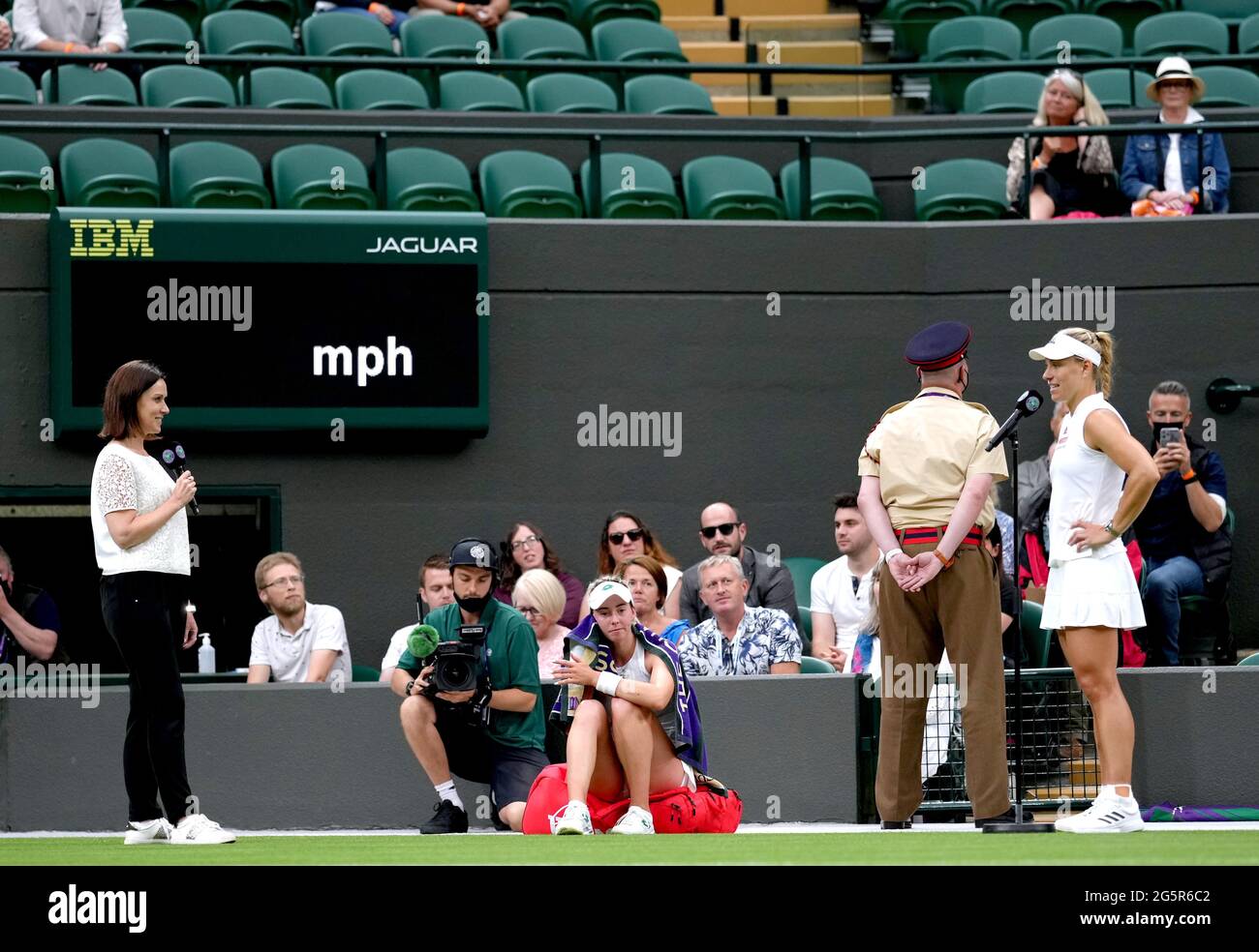 Angelique Kerber (right) is interviewed by Lee McKenzie after winning her first round ladies' singles match against Nina Stojanovic (centre) on court one on day two of Wimbledon at The All England Lawn Tennis and Croquet Club, Wimbledon. Picture date: Tuesday June 29, 2021. Stock Photo