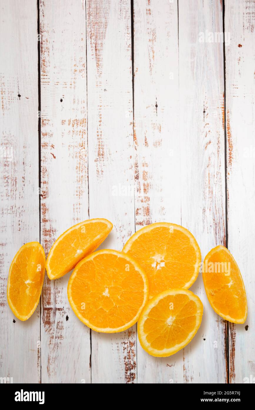 Top view orange fruit slices on wooden table Stock Photo