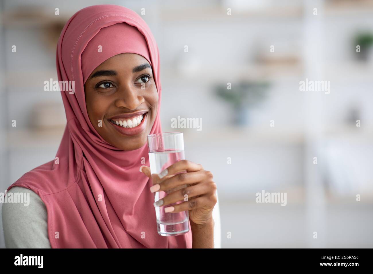Closeup Of Black Woman In Hijab Drinking Water From Glass At Home Stock ...