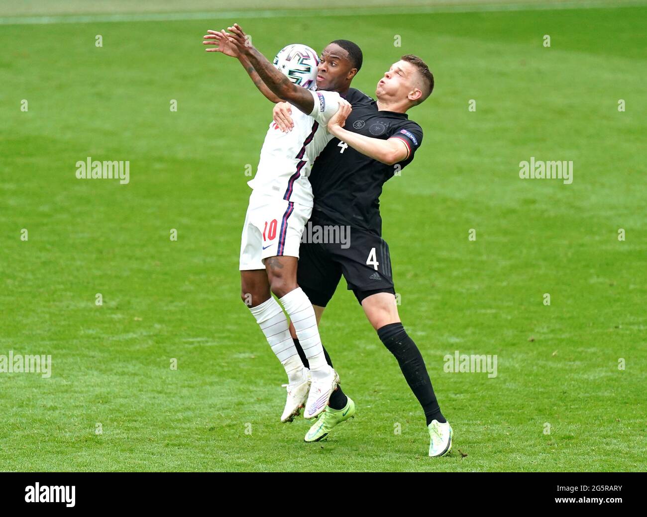 England's Raheem Sterling (left) and Germany's Matthias Ginter battle for the ball during the UEFA Euro 2020 round of 16 match at Wembley Stadium, London. Picture date: Tuesday June 29, 2021. Stock Photo