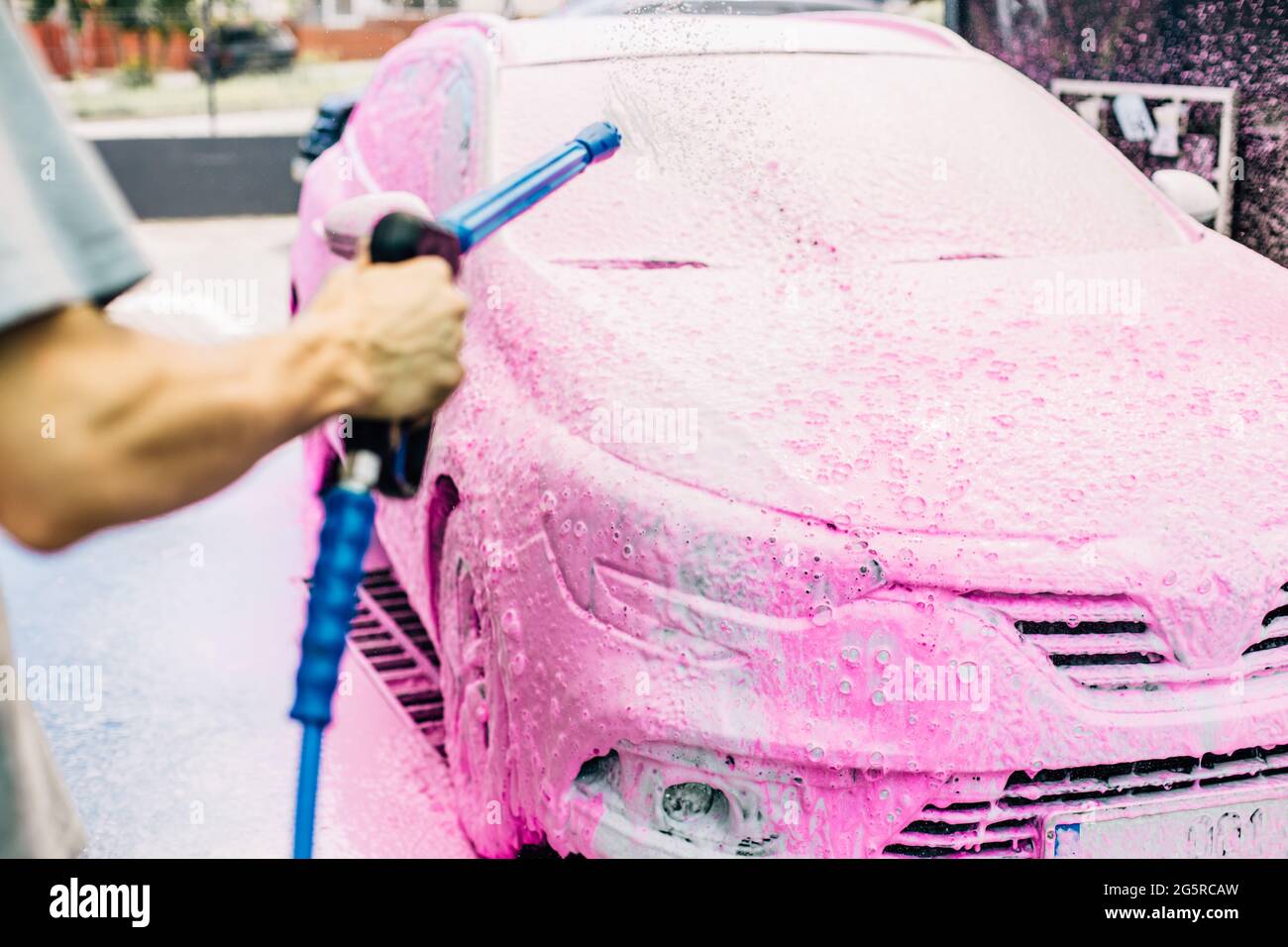 Manual car wash with pressure water on the street, Summer car wash, Car