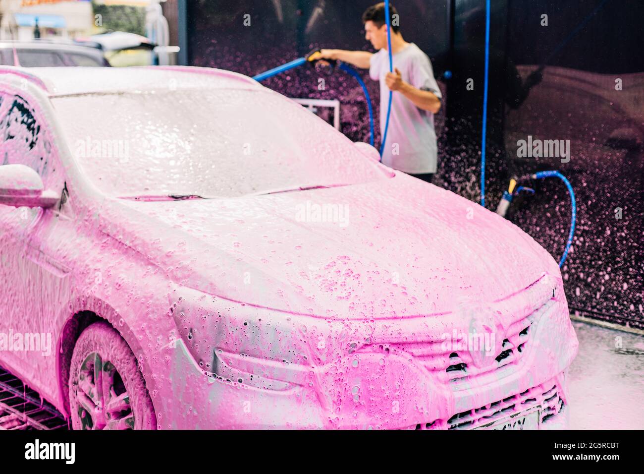 Manual car wash with pressure water on the street, Summer car wash, Car