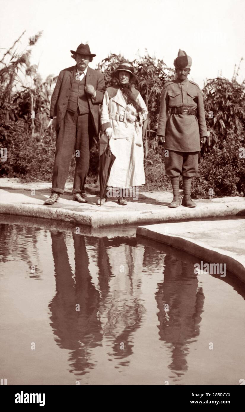 G.K. Chesterton (left) and his wife, Frances Chesterton, visiting Elisha's Fountain near Jericho in early 1920 on a trip to the Holy Land. Stock Photo