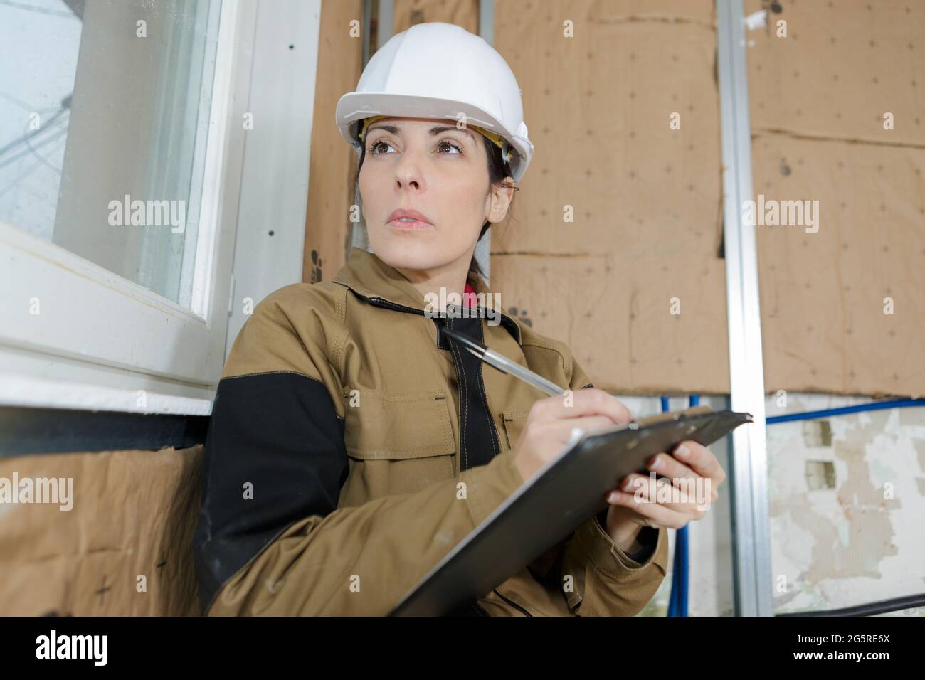 architect holding blueprints and a clipboard Stock Photo Alamy