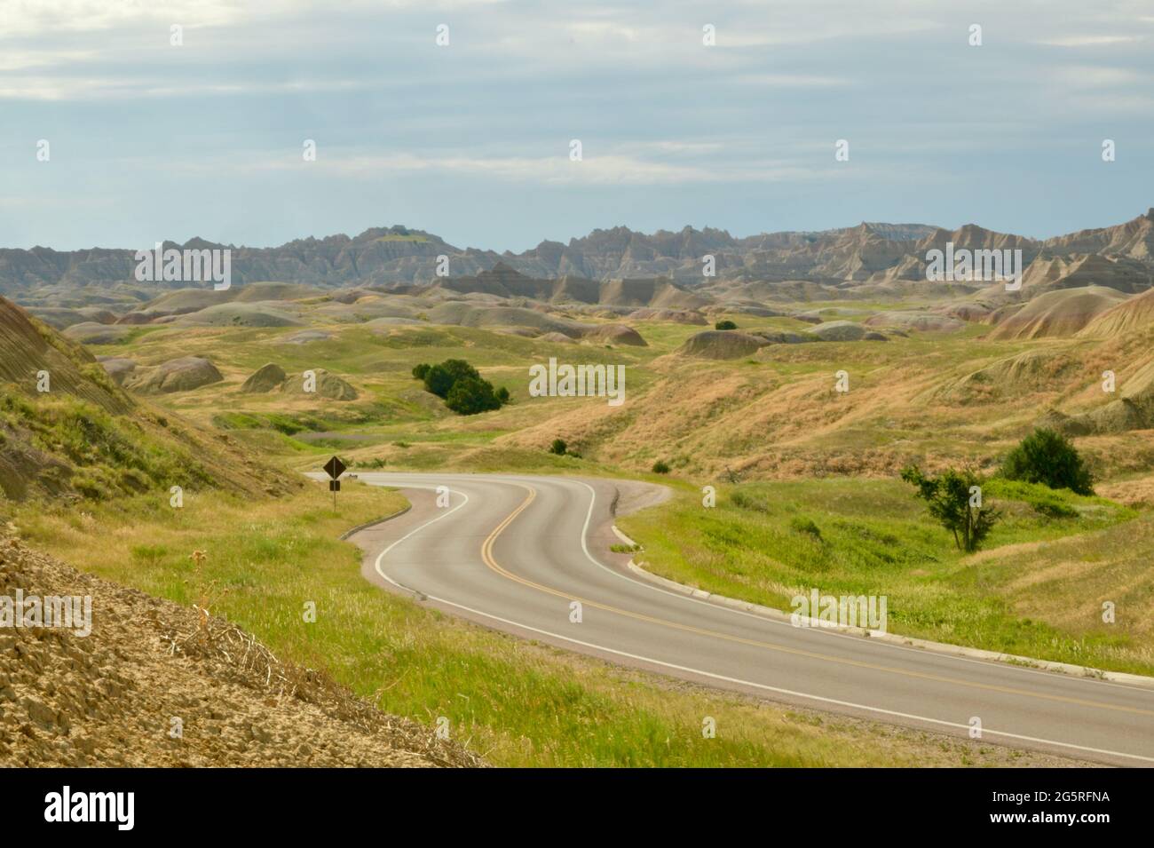 Winding Road through the Yellow Mounds in the Badlands National Park, with Eroded Buttes, Grasslands and Pinnacles in South Dakota, USA Stock Photo