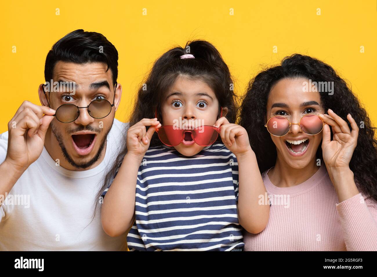 Summer Offer. Excited Arab Mother, Father And Daughter Wearing Colorful Modern Sunglasses Stock Photo