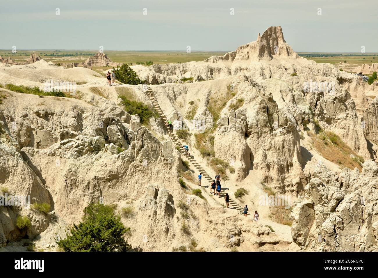 Hiking the Notch Trail in the Badlands National Park. Taking a log ladder up Eroded Buttes and Pinnacles to the Notch in South Dakota, USA Stock Photo