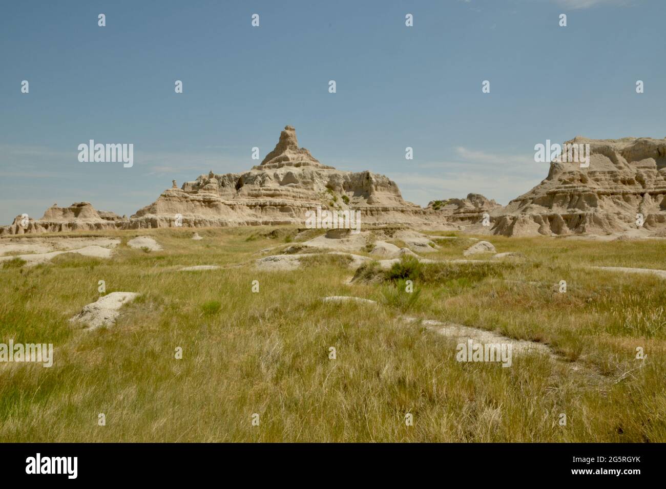 View of Rock Formations, Chadron Formations,through the grassland in the Badlands National Park Eroded Buttes and Pinnacles in South Dakota, USA Stock Photo