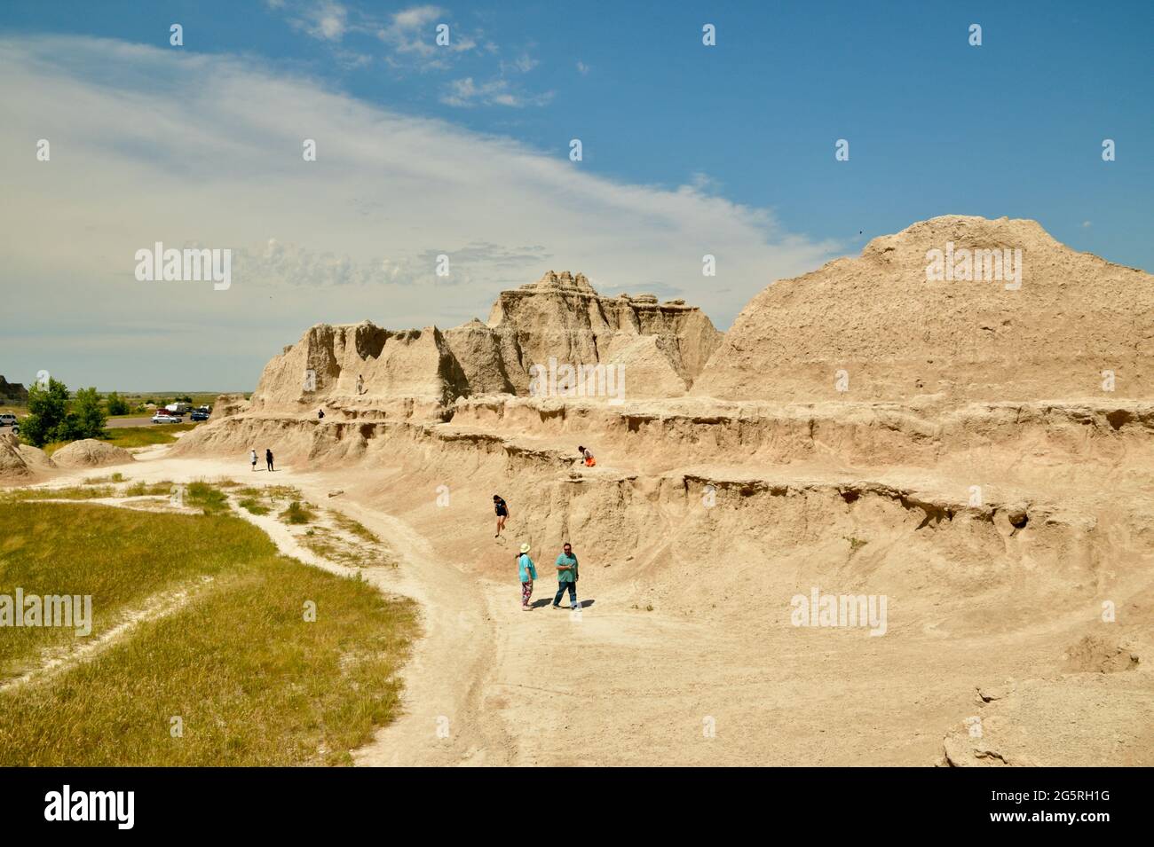 People hiking the Rock Formations, Chadron Formations, in the Badlands National Park Eroded Buttes and Pinnacles in South Dakota, USA Stock Photo