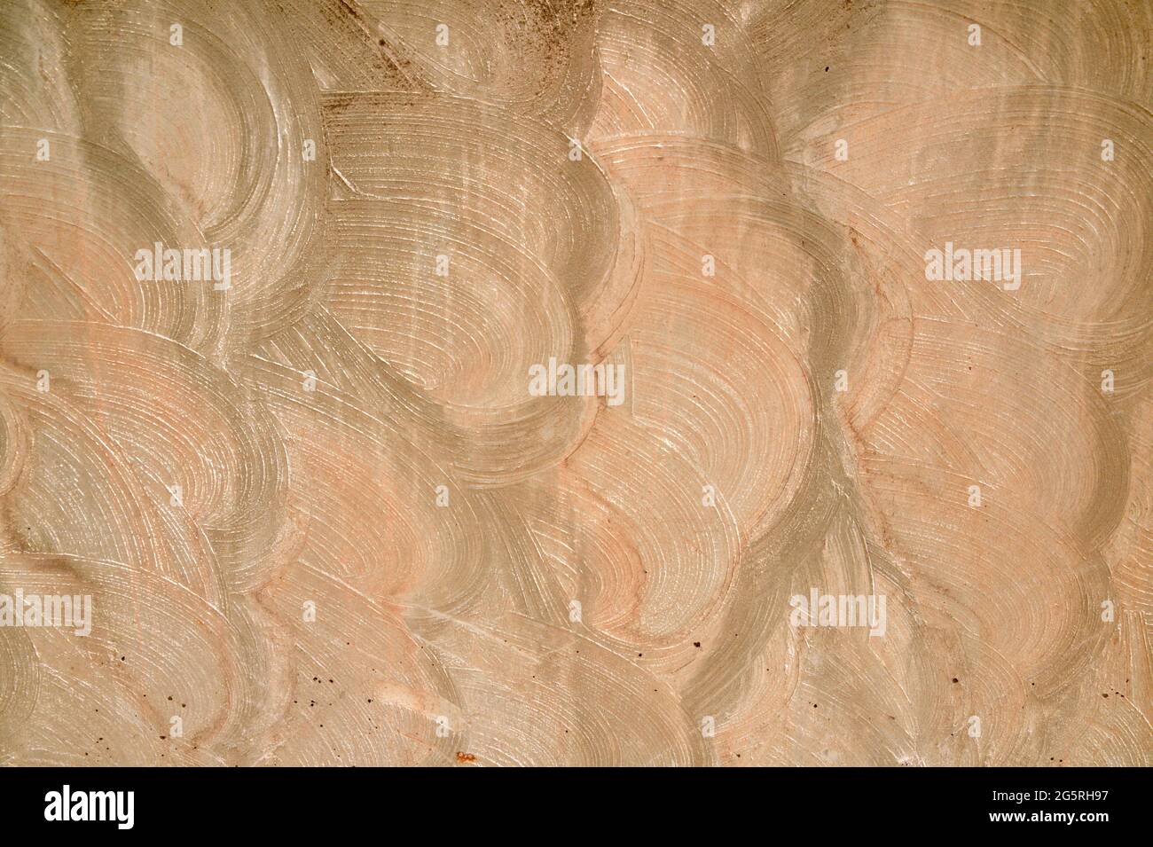 Abstract, multi-colored swirled stucco, or plaster, wall background. Stock Photo