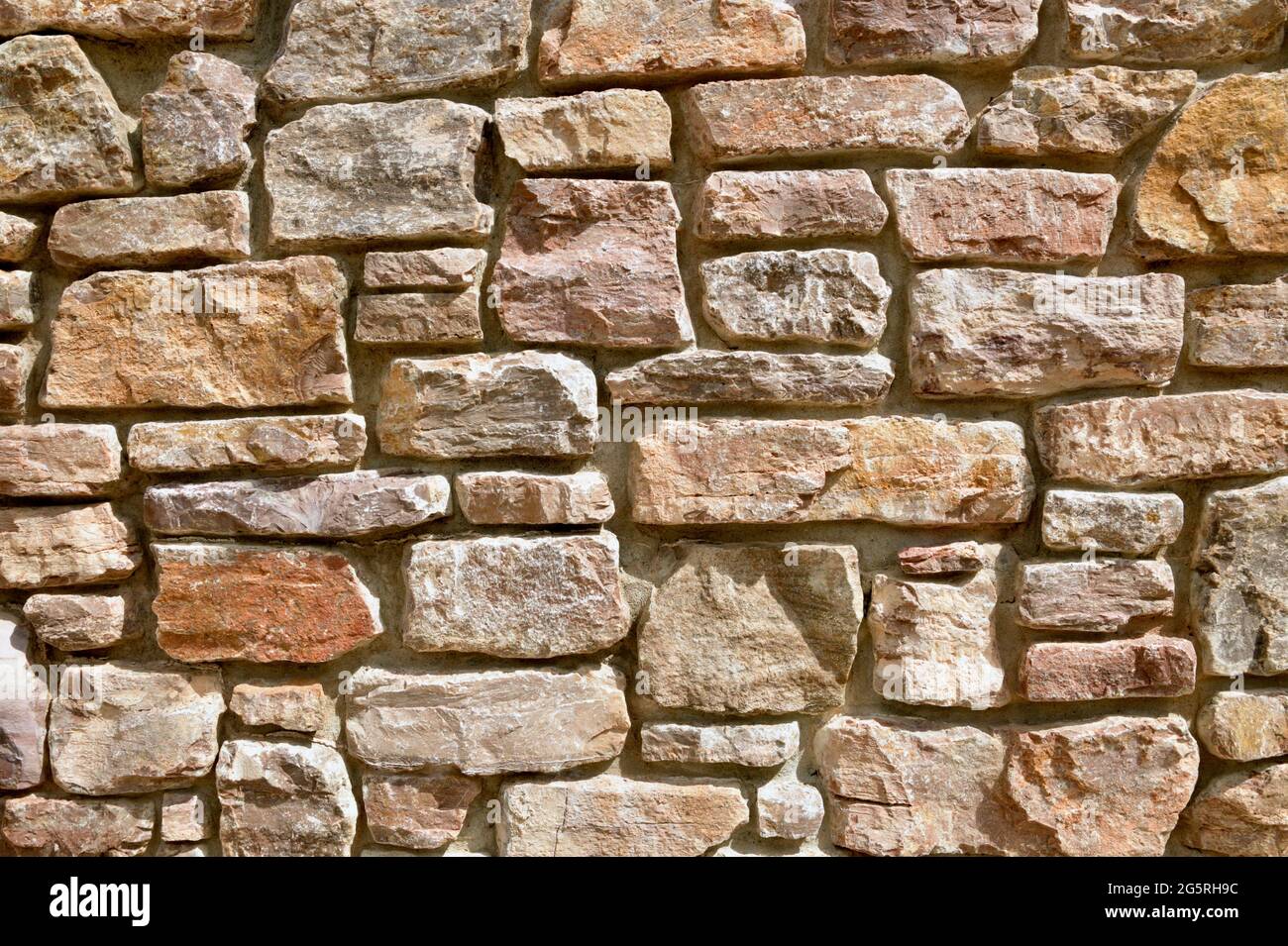 Multi-colored, Abstract Granite and Shale Stacked, Retaining Rock Walls Stock Photo
