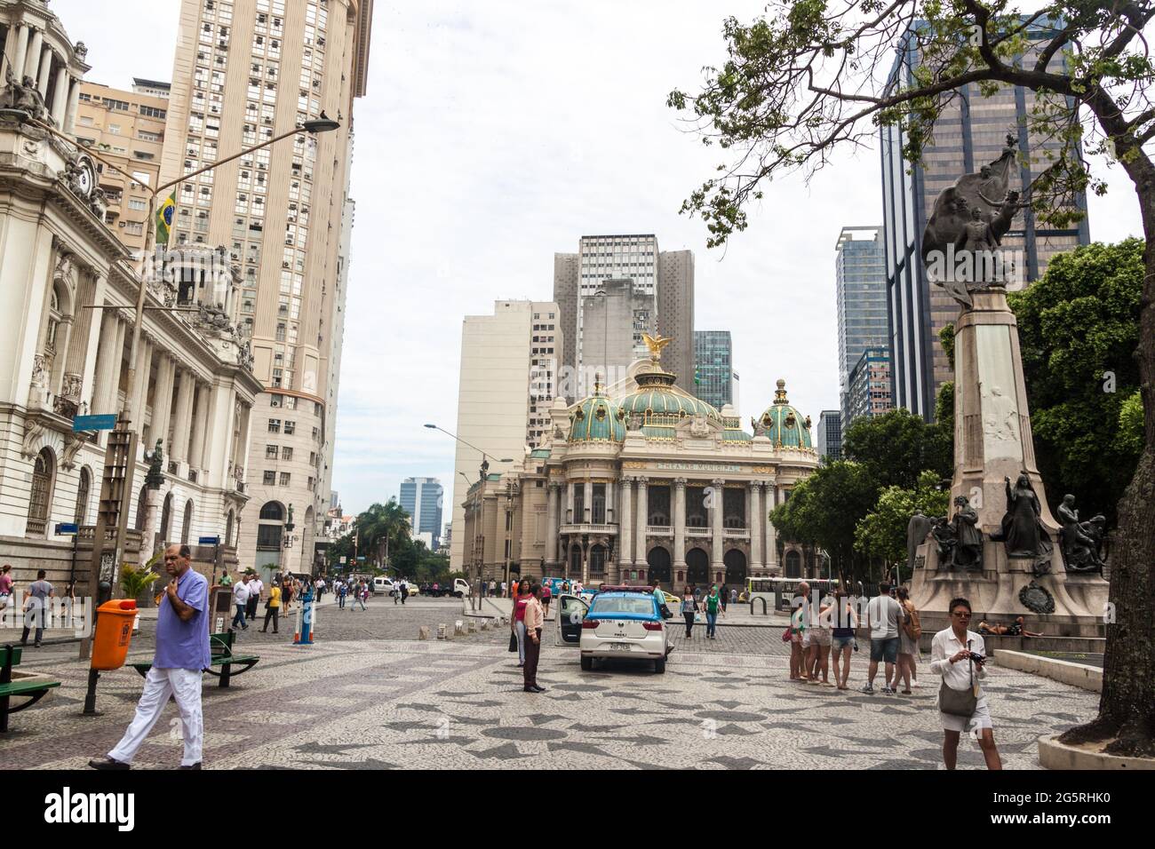 RIO DE JANEIRO, BRAZIL - JANUARY 28, 2015: People walk on Praca Alagoas suare in front of the Town Hall  and the Municipal Theatre in Rio de Janeiro. Stock Photo