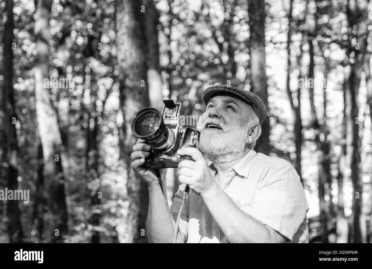 Retro Camera. Capture the moment. Pension and retirement. Vintage stylized photo of man photographer with old Camera. autumn nature background. Smile Stock Photo