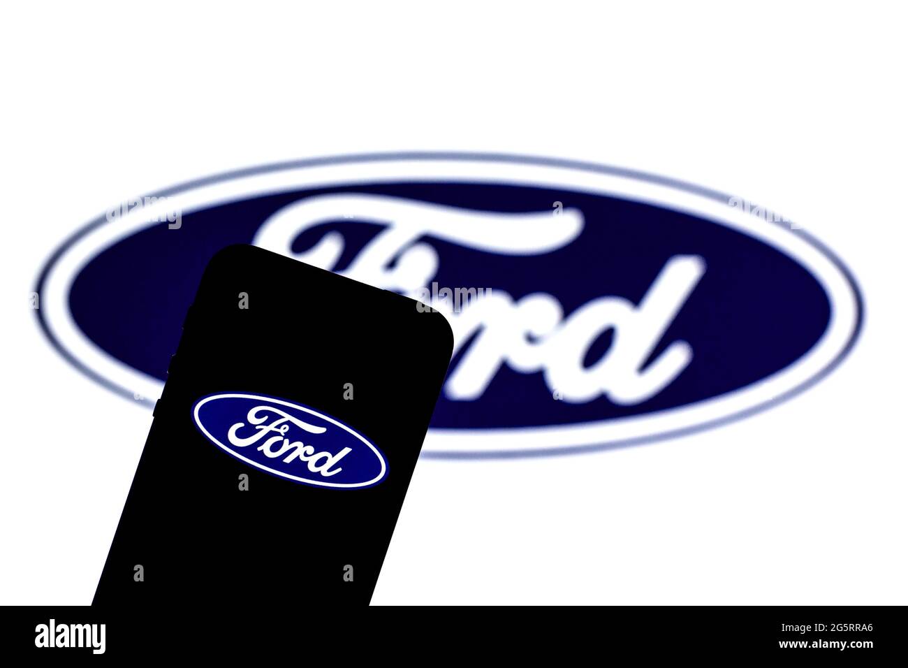 In this photo illustration a Ford Motor Company logo seen displayed on
