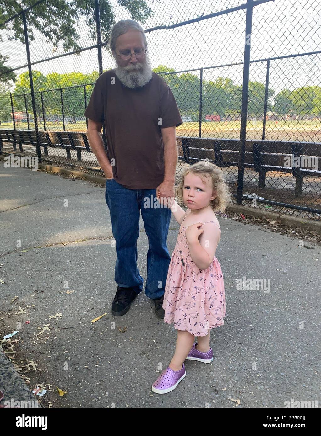 Portrait of a small girl with Grandpa in hand, Parade Grounds, Brooklyn, New York. Stock Photo