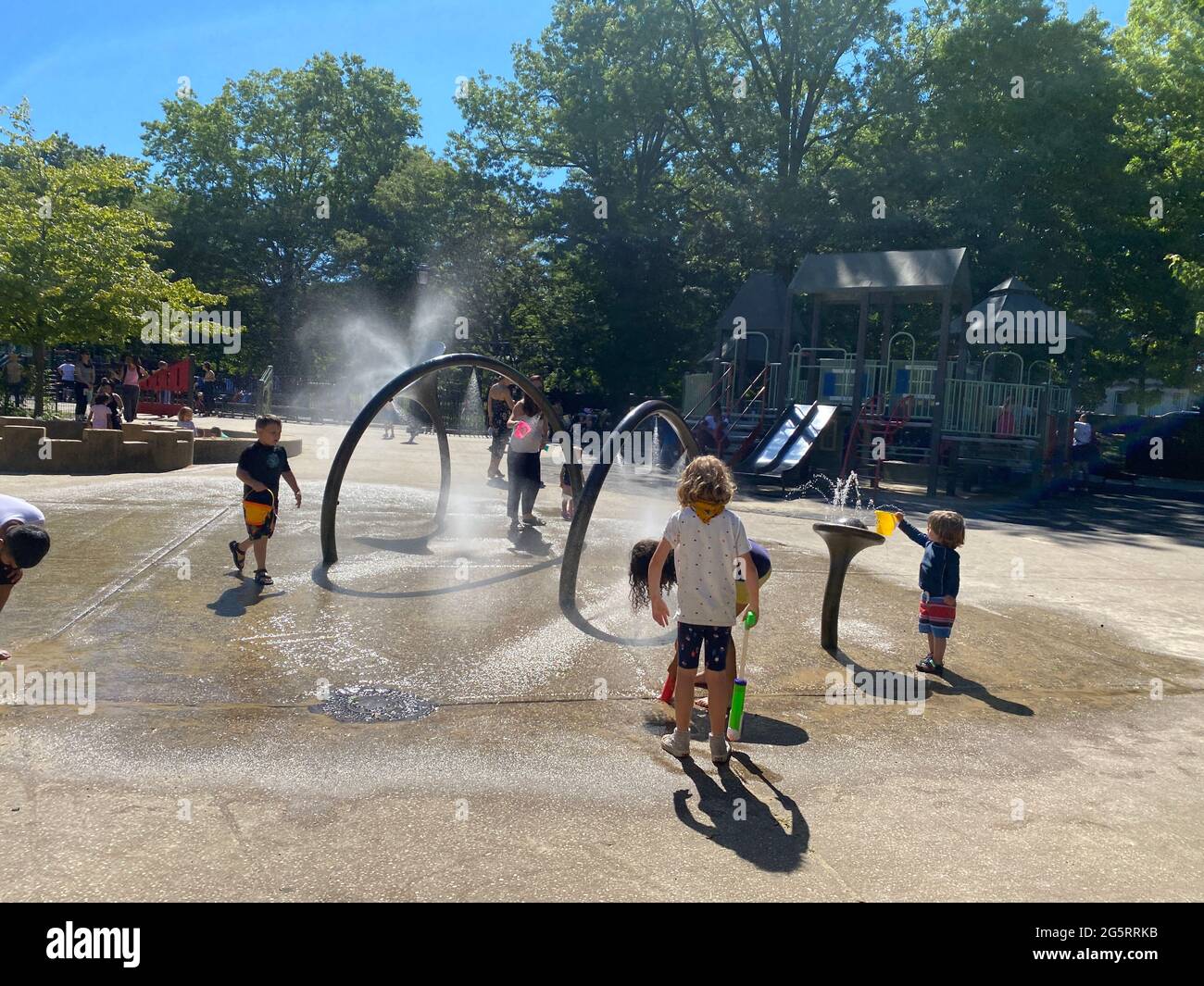 Kids play in the cooling off section of a playground in Prospect Park, Brooklyn, New York. Stock Photo