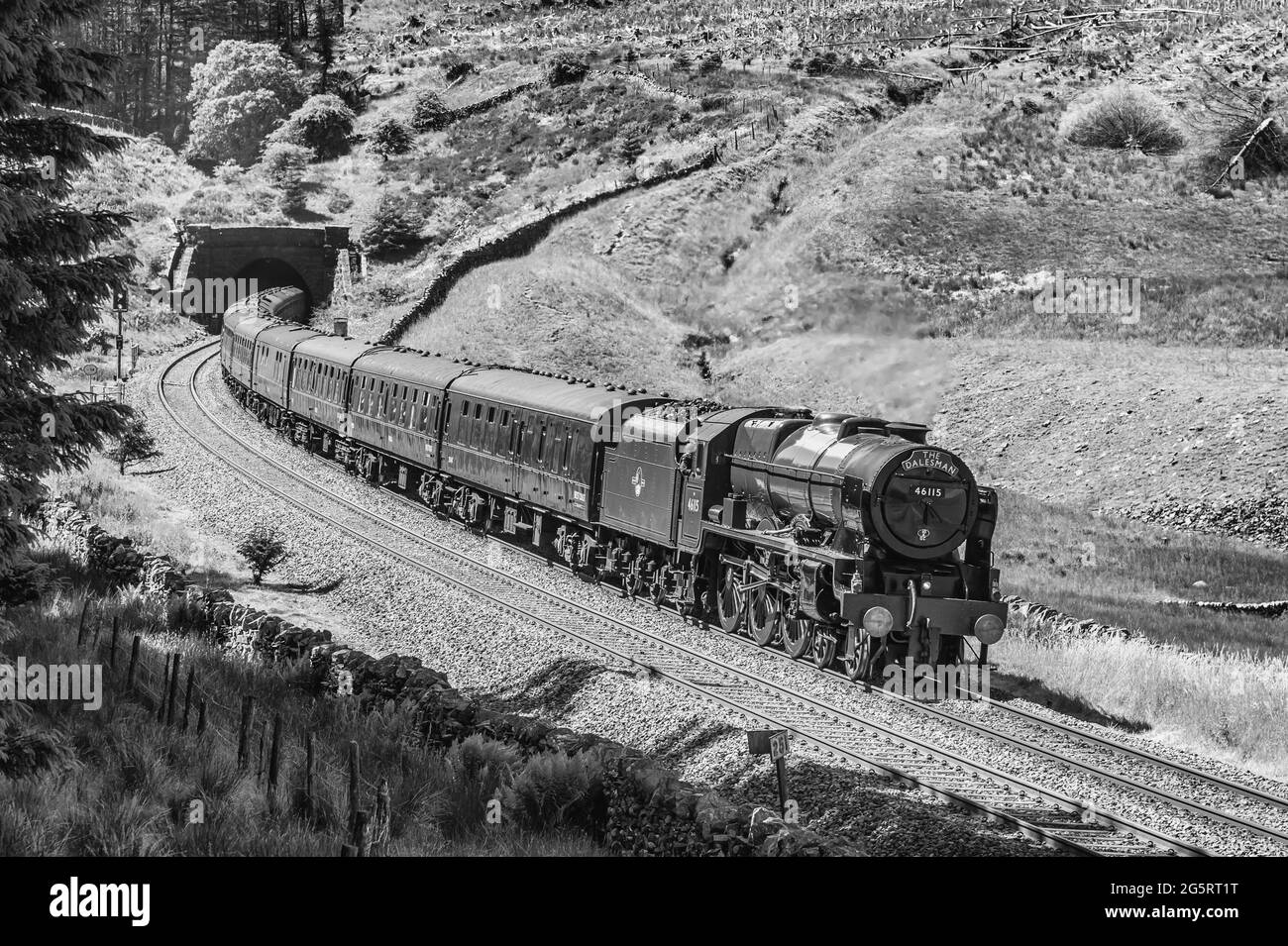 This is the Dalesman headed by Royal Scot Class 7P, 4-6-0, 46115 Scots Guardsman steam train exiting Blea Moor tunnel in the Yorkshire Dales Stock Photo