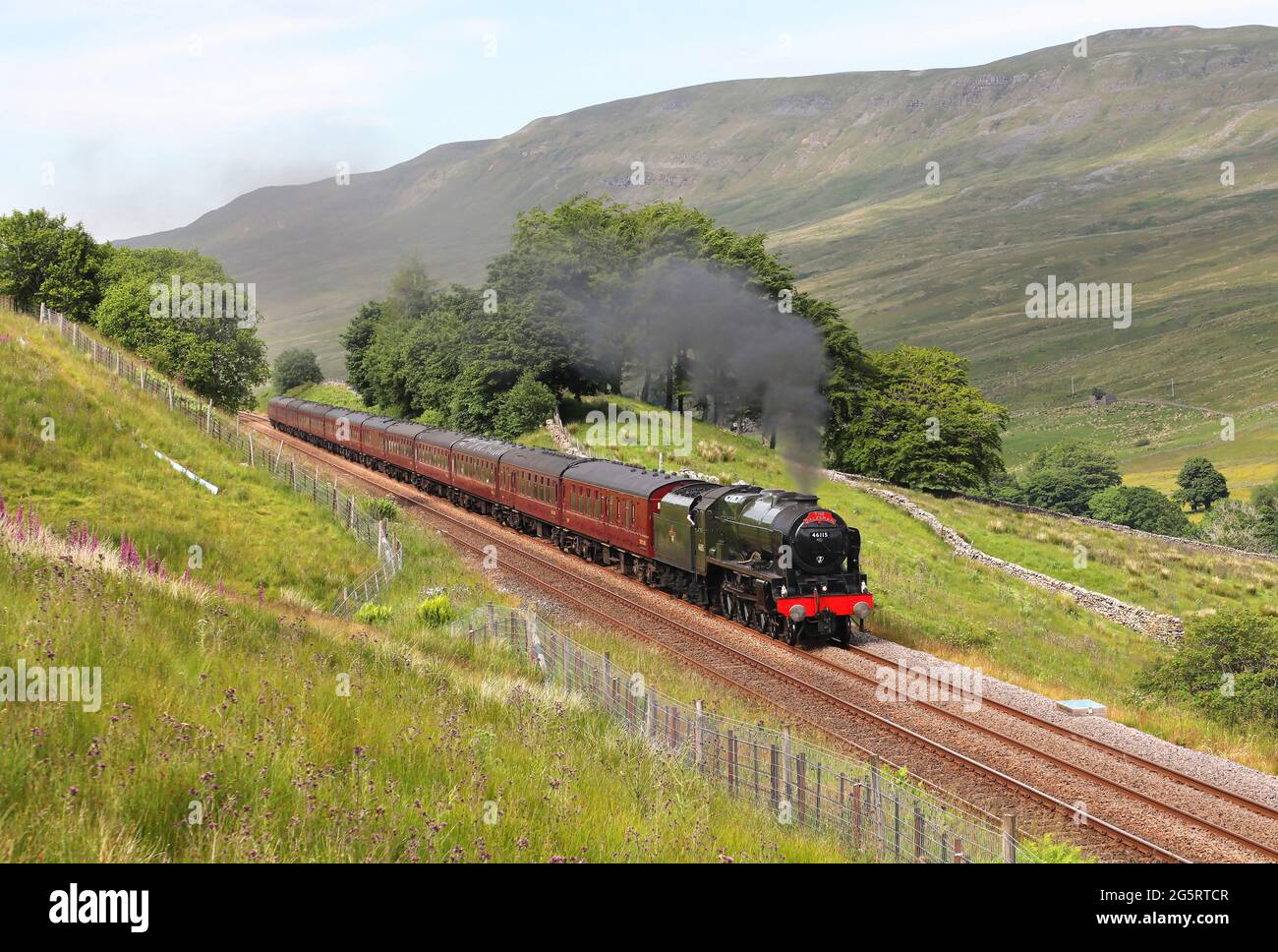 46115 works the returning 'Pendle Dalesman. past Angrholm on 29.6.21. Stock Photo