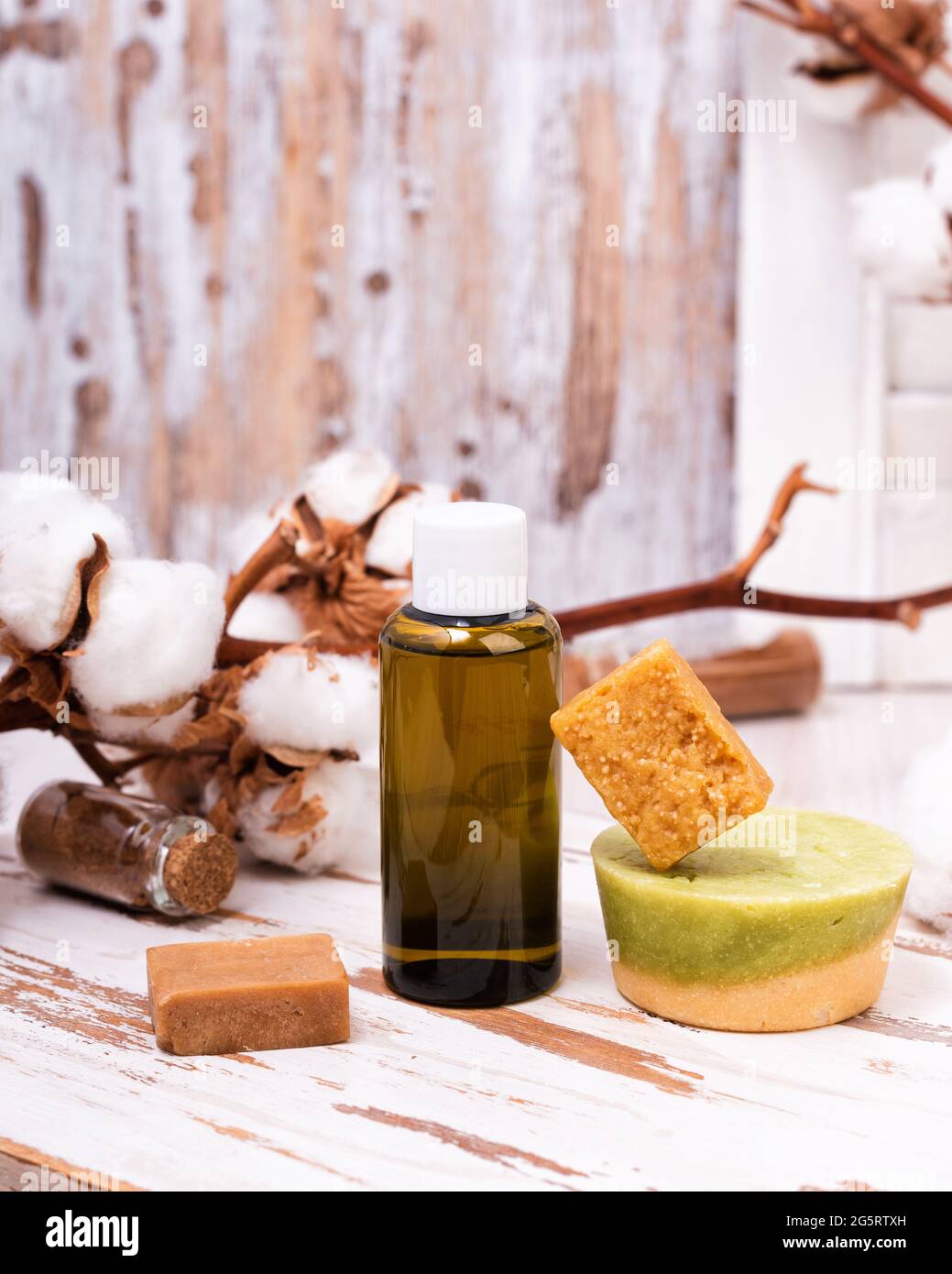 Solid bars of organic shampoo, conditioner and bottle of shower gel