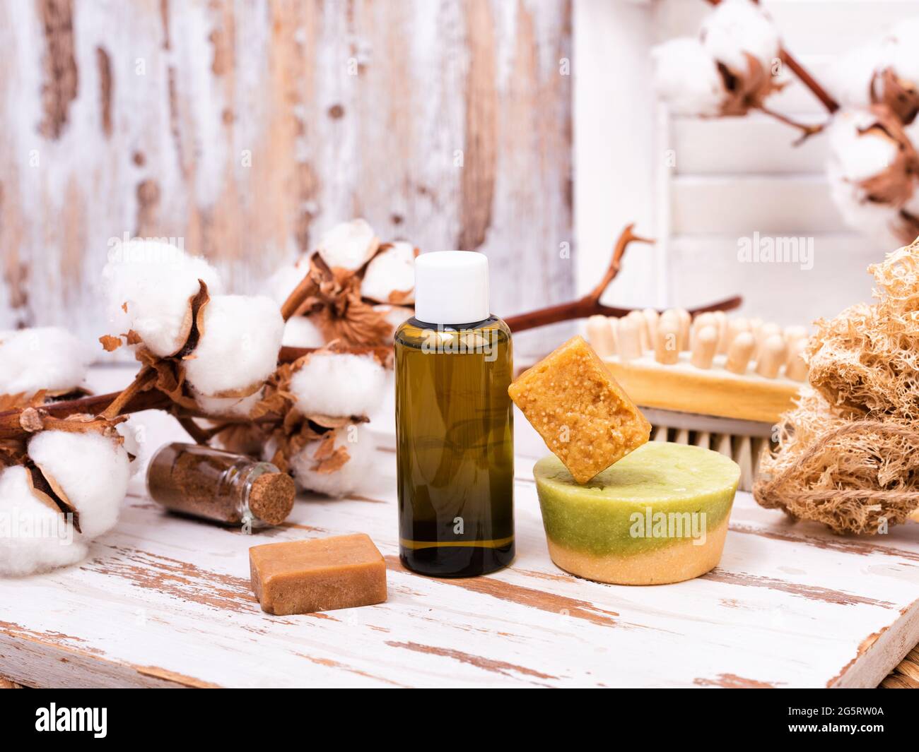 Solid bars of organic shampoo, conditioner and bottle of shower gel