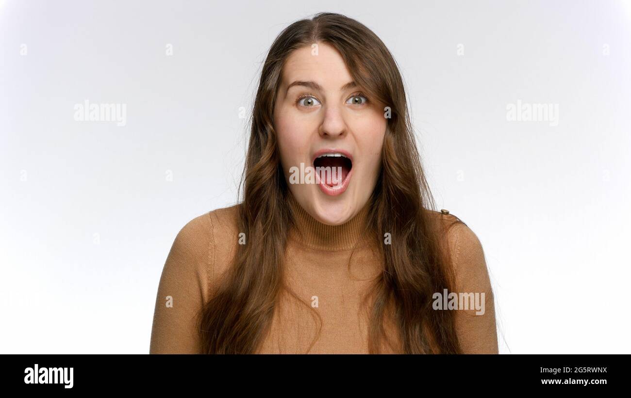 Portrait of amazed and surprised woman saying Wow. Positive emotions ...