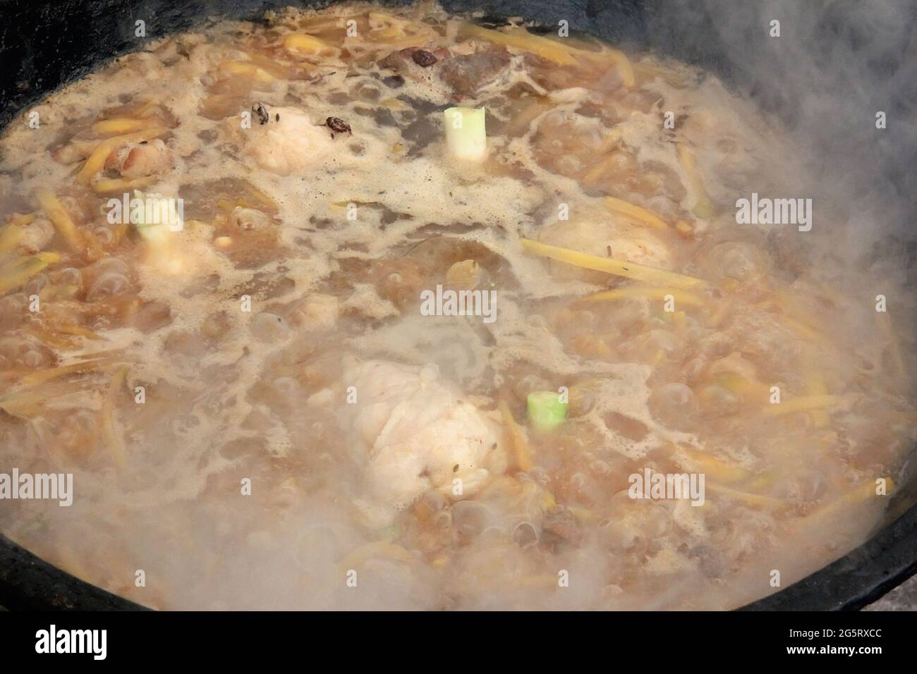 Pieces of raw lamb fat dumba are fried in a black cauldron, cooking food  Stock Photo - Alamy