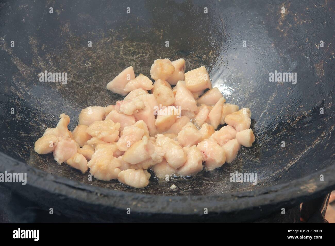 https://c8.alamy.com/comp/2G5RXCN/pieces-of-raw-lamb-fat-dumba-are-fried-in-a-black-cauldron-cooking-food-2G5RXCN.jpg