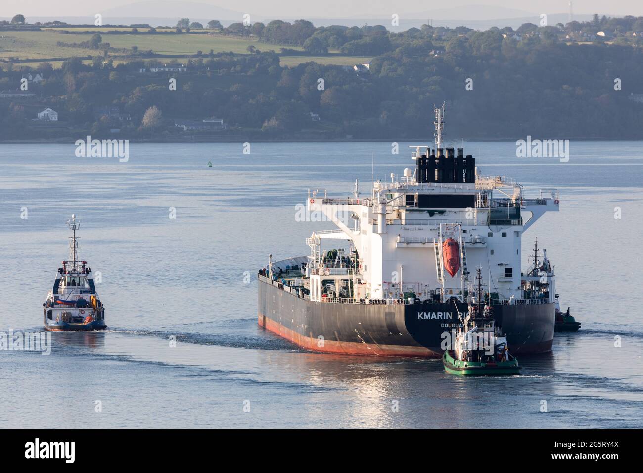 Cork Harbour, Cork, Ireland. 29th June, 2021. Oil tanker Kmarin Rigour steams through Cork Harbour escorted by tugs Ocean Challanger and DSG Titan after a voyage from Corpus Christi Texas with a supply of crude for the refinery at Whitegate, Co. Cork, Ireland. - Picture; David Creedon / Alamy Live News Stock Photo