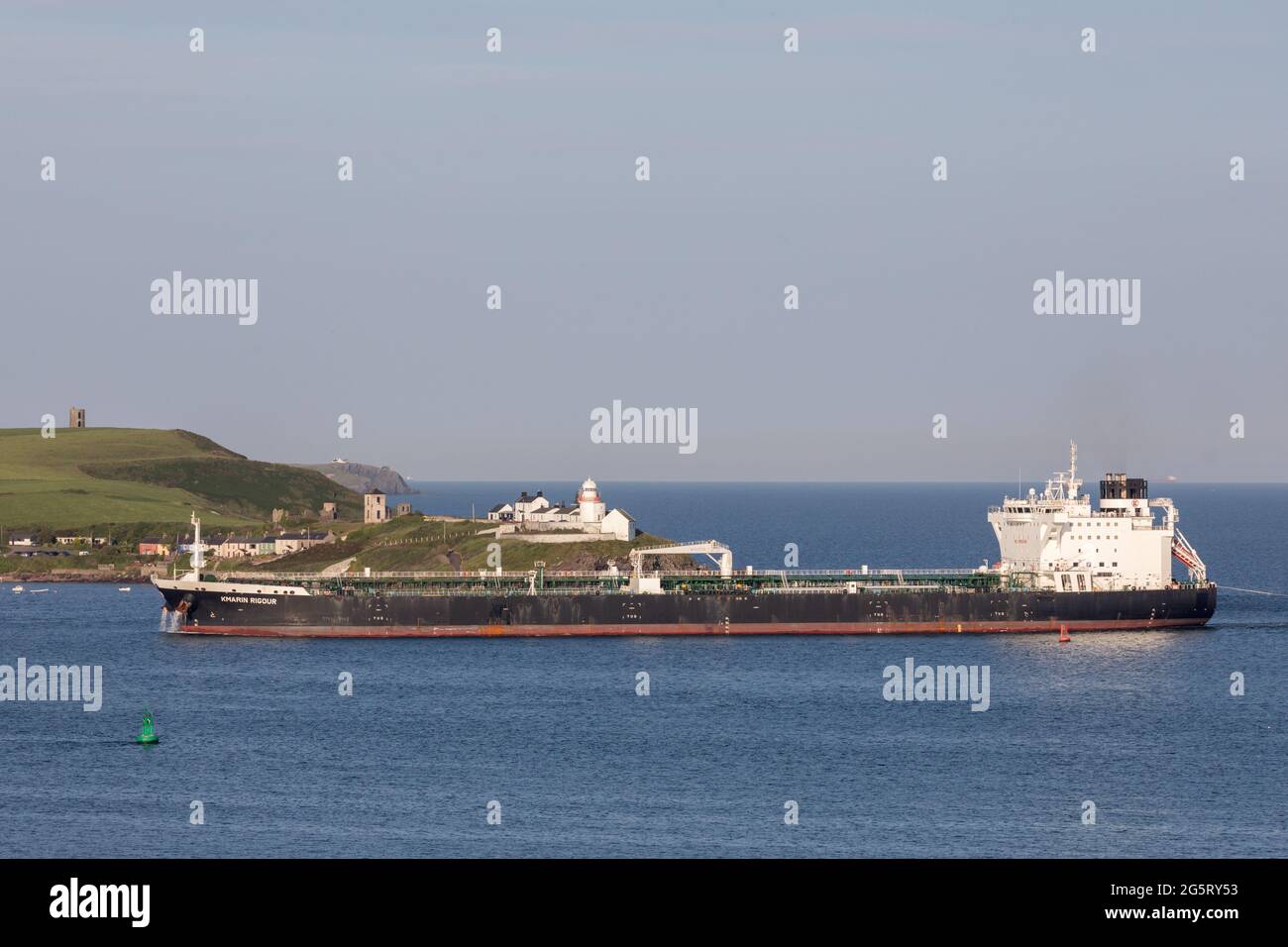 Cork Harbour, Cork, Ireland. 29th June, 2021. Oil tanker Kmarin Rigour passes Roches Point lighthouse after a voyage from Corpus Christi Texas with a supply of crude for the refinery at Whitegate, Co. Cork, Ireland. - Picture; David Creedon / Alamy Live News Stock Photo