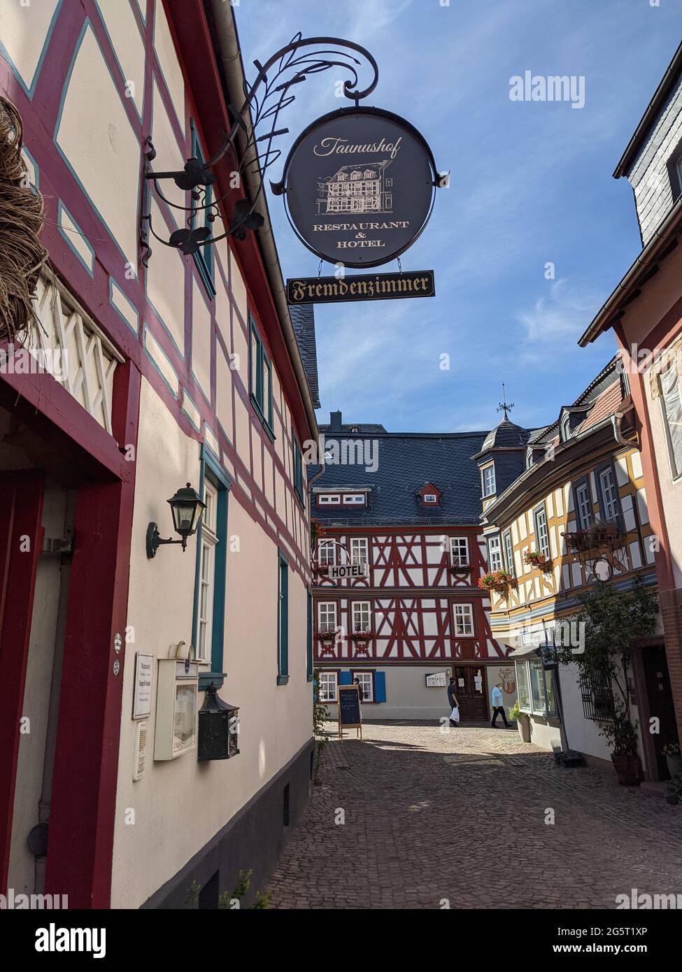 Beautiful alley in the old town of Idstein, Germany. Bunte Gasse mit Fachwerkhäusern in der historischen Altstadt von Idstein, Hessen, Deutschland. Stock Photo