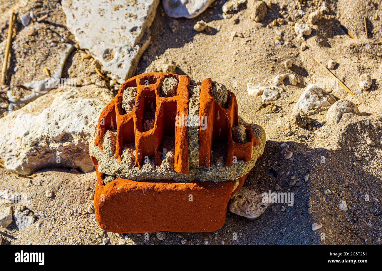 Brick on the beach. Brick in the sea. The stone is snoused with water ...