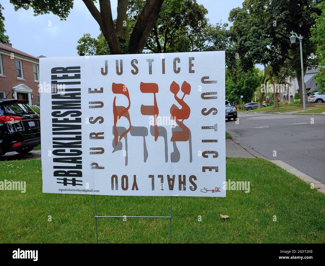 Toronto, Canada - June 29, 2021:  Lawn sign with Hebrew biblical quote about pursuing justice, Jewish support for Black Lives Matter Stock Photo