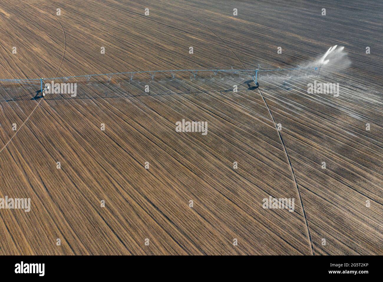 Aerial view about center pivot irrigation system spraying crops. Farm concept, modern watering equipment, agriculture texture. Stock Photo