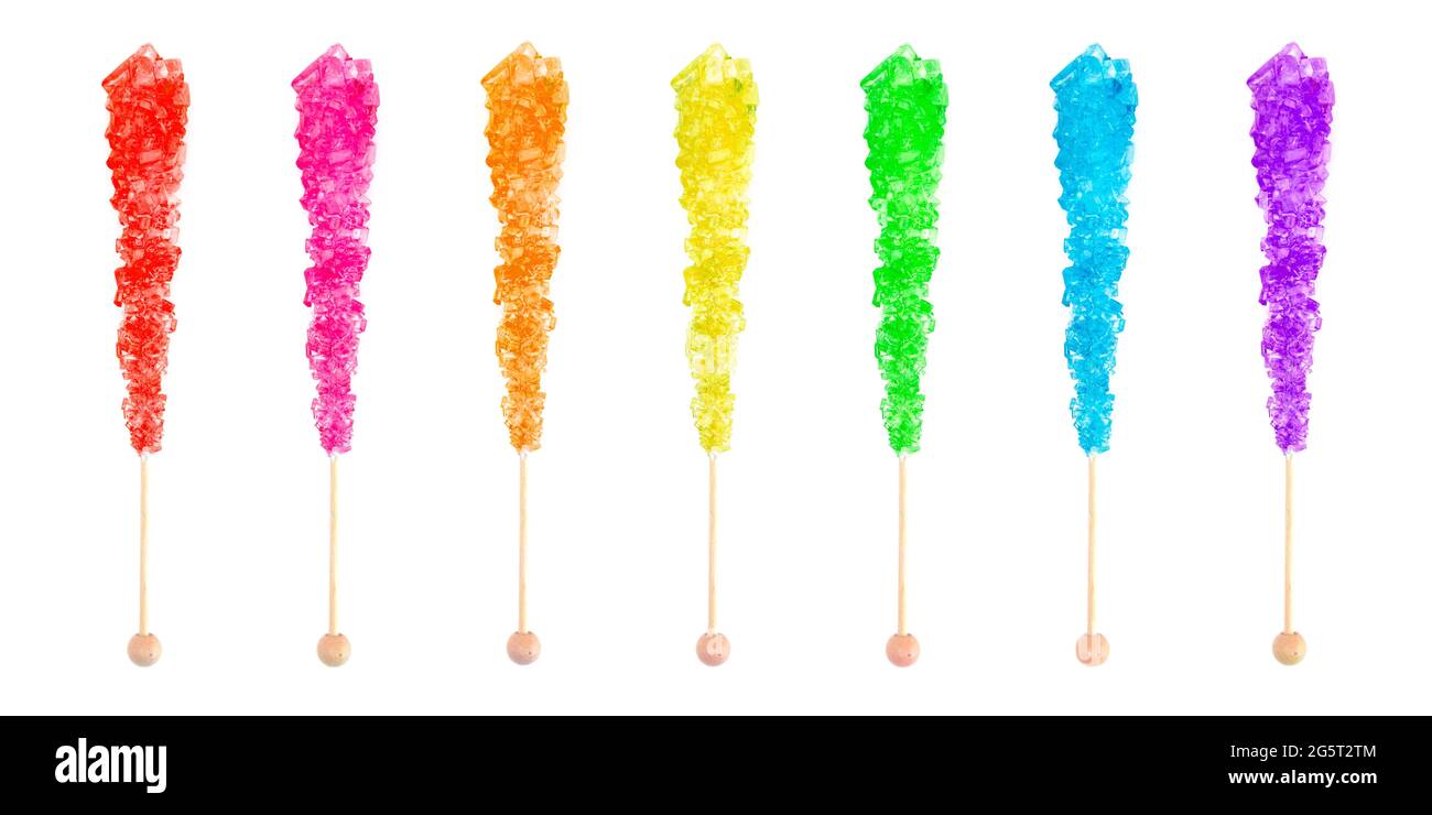 Row of Seven Rainbow Colored Rock Candies on a Stick Stock Photo