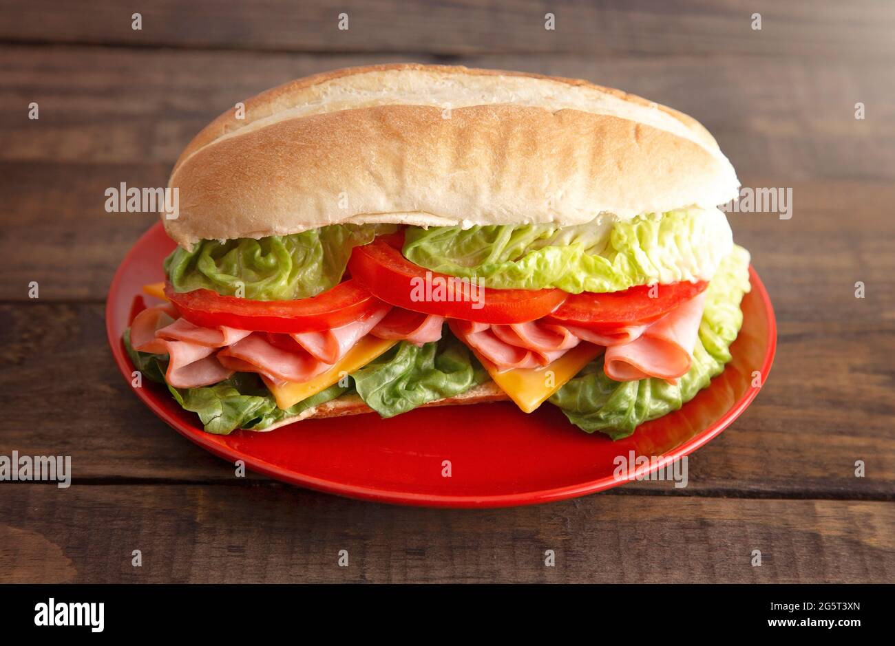 A Single Ham Sandwich with Lettuce Cheese and Tomatoes on a White Bun ...