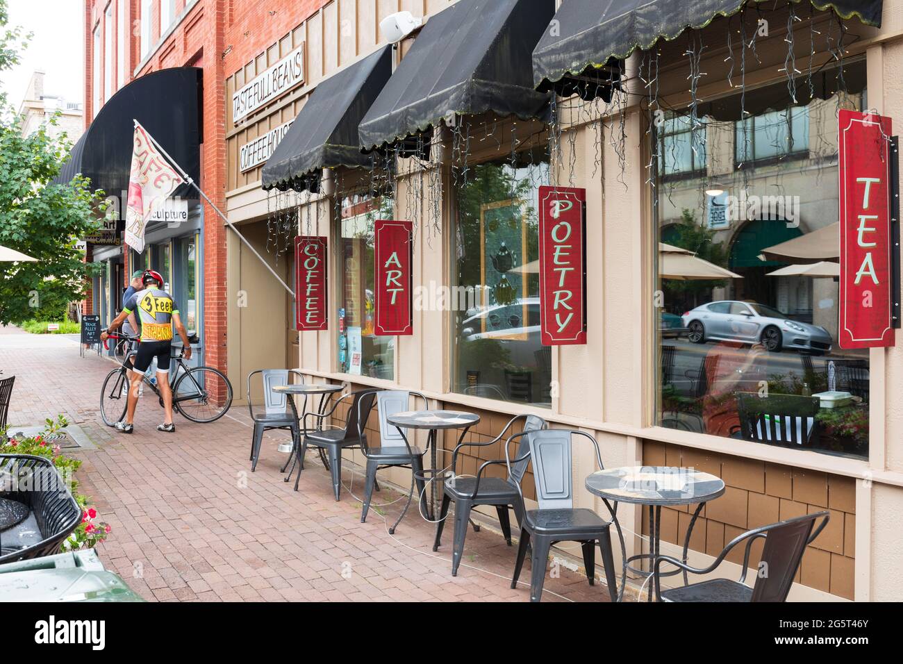 HICKORY, NC, USA-22 JUNE 2021: Front diagonal view of Taste Full Beans Coffeehouse,  customer exiting with racing bike and apparel. Stock Photo