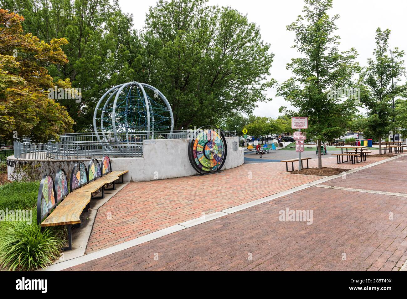 HICKORY, NC, USA-22 JUNE 2021: Lowes Foods City Park, a playground for children in downtown. Two people walking in distance. Stock Photo