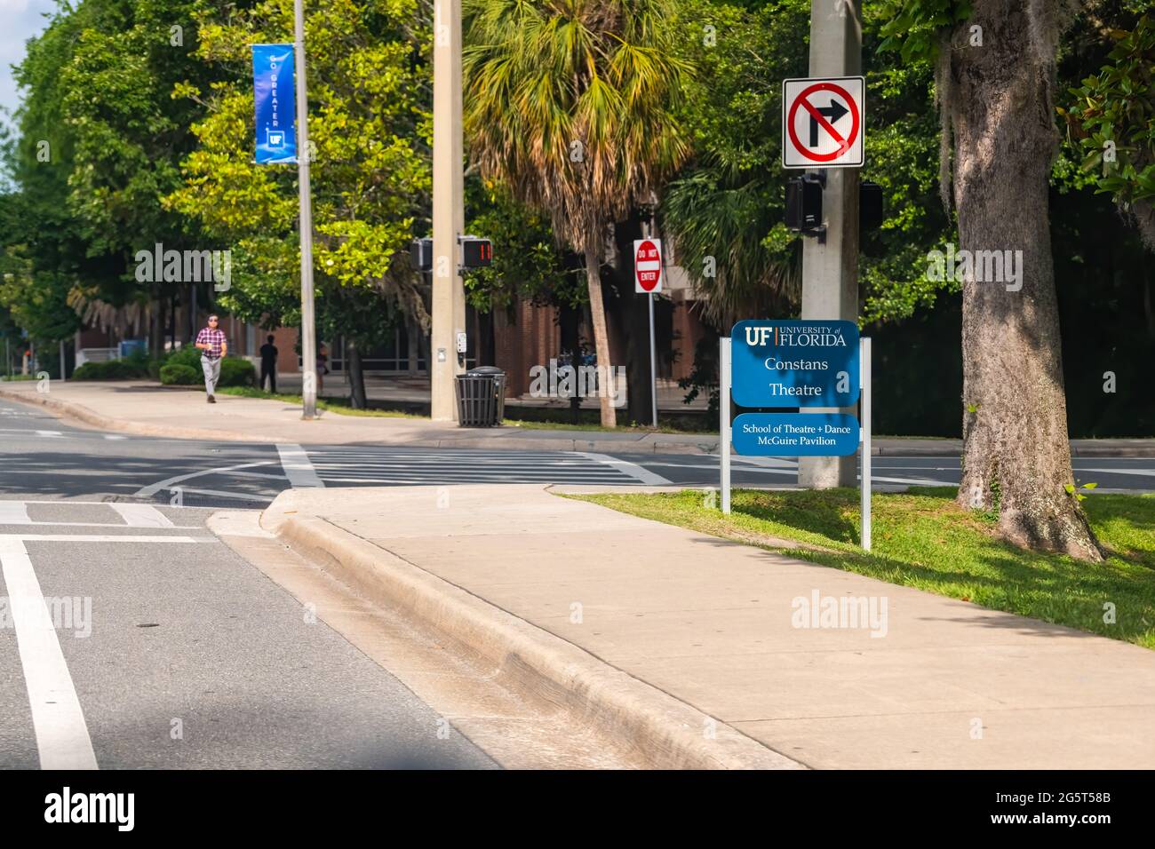 Gainesville, USA - April 27, 2018: University of Florida sign for constans theatre and dance mcguire pavilion on UF campus with students walking on si Stock Photo