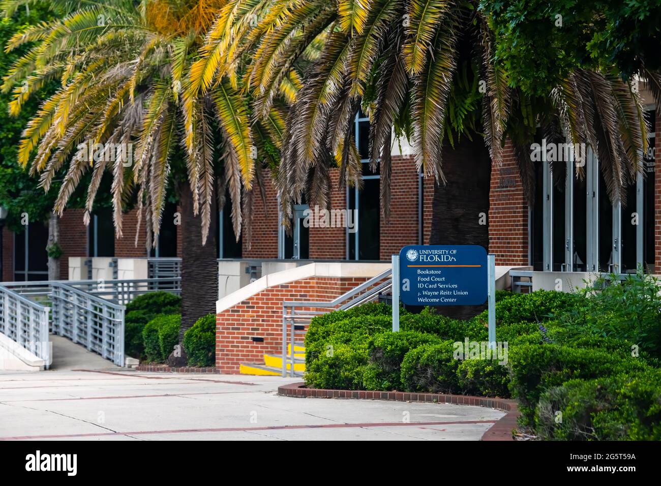 Gainesville, USA - April 27, 2018: University of Florida sign on UF campus with building for bookstore, food court, id card services and welcome cente Stock Photo