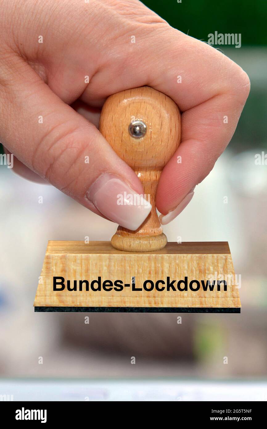 woman's hand with stamp with the label Bundes-Lockdown, Federal-Lockdown Stock Photo