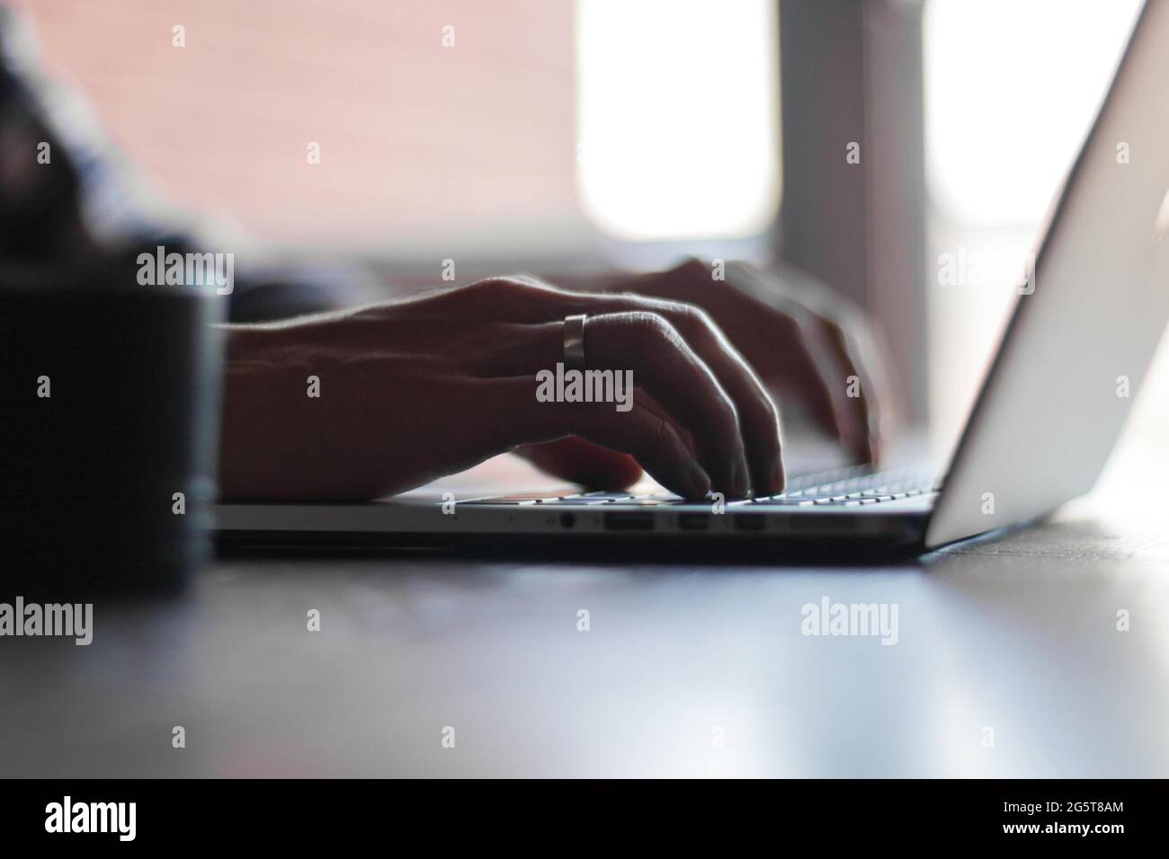 A man typing into keyboard for marketing agency, professionnal business work. Stock Photo